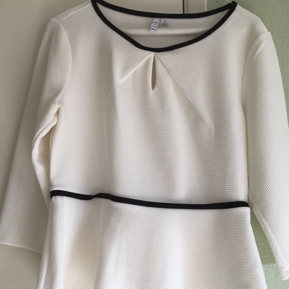 White flowy top from Elle with black trim.